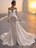 Woman in a white and silver gown with 'Ivana Elsie' branding against a sunset backdrop.