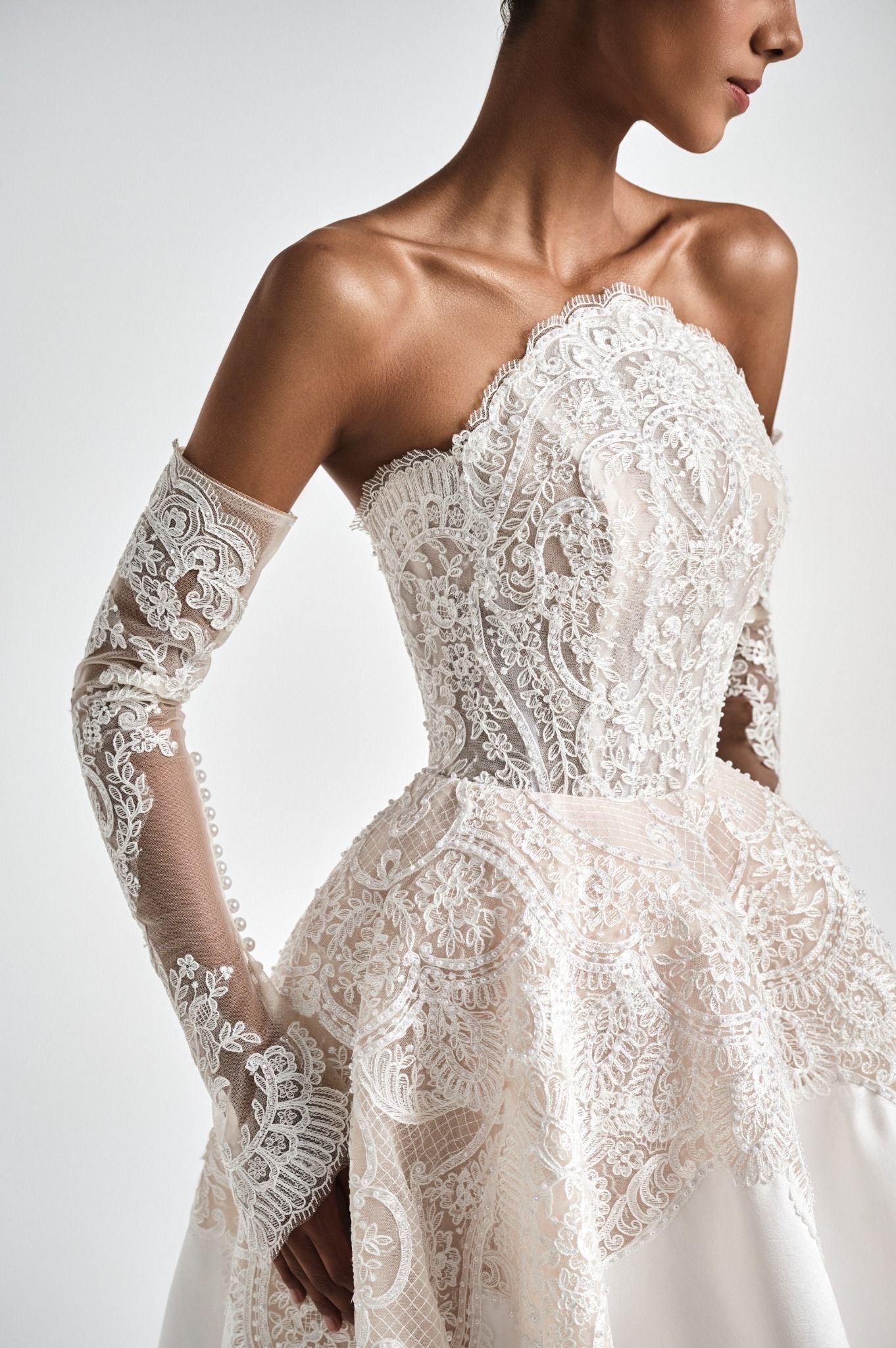 Lace wedding dress with long sleeves on a white background