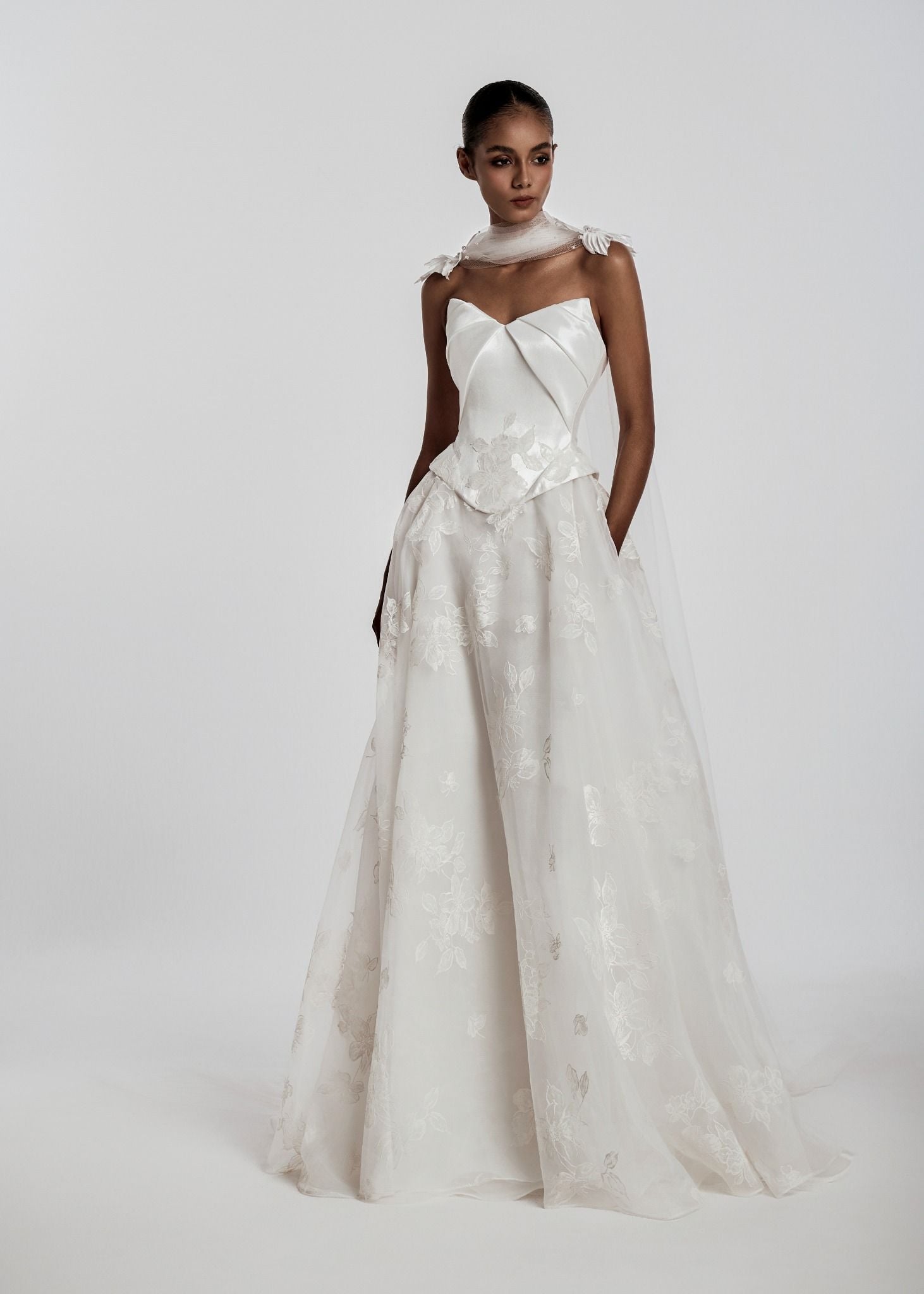White wedding dress with a large bow on a white background